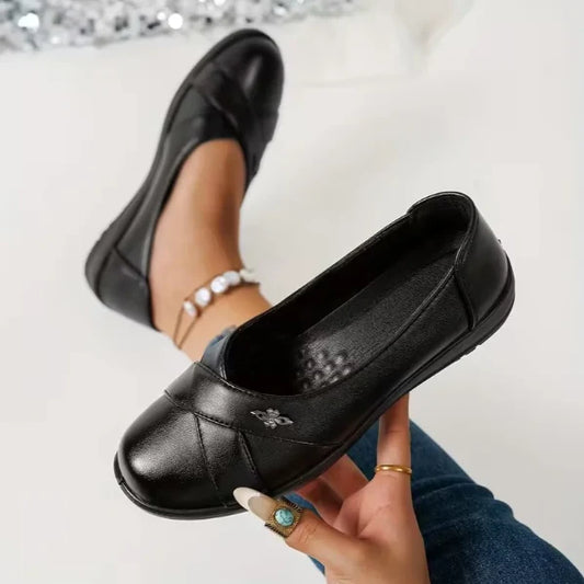 Women’s Leather-Look Supportive Slip-On Shoes With Metal Emblem